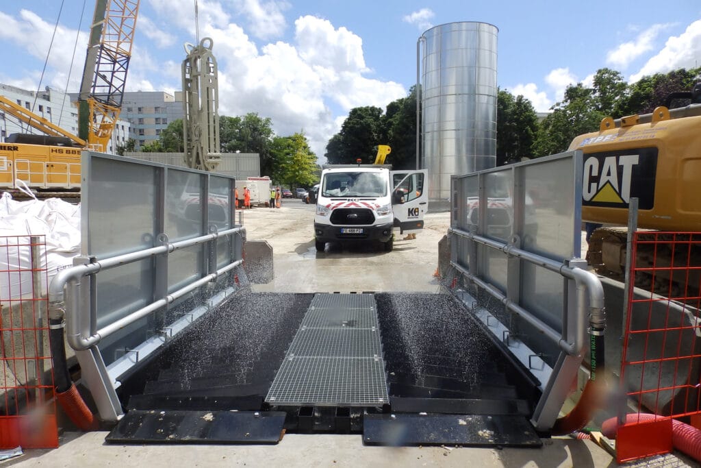 A vehicle in front of a World Laveur wheel washer